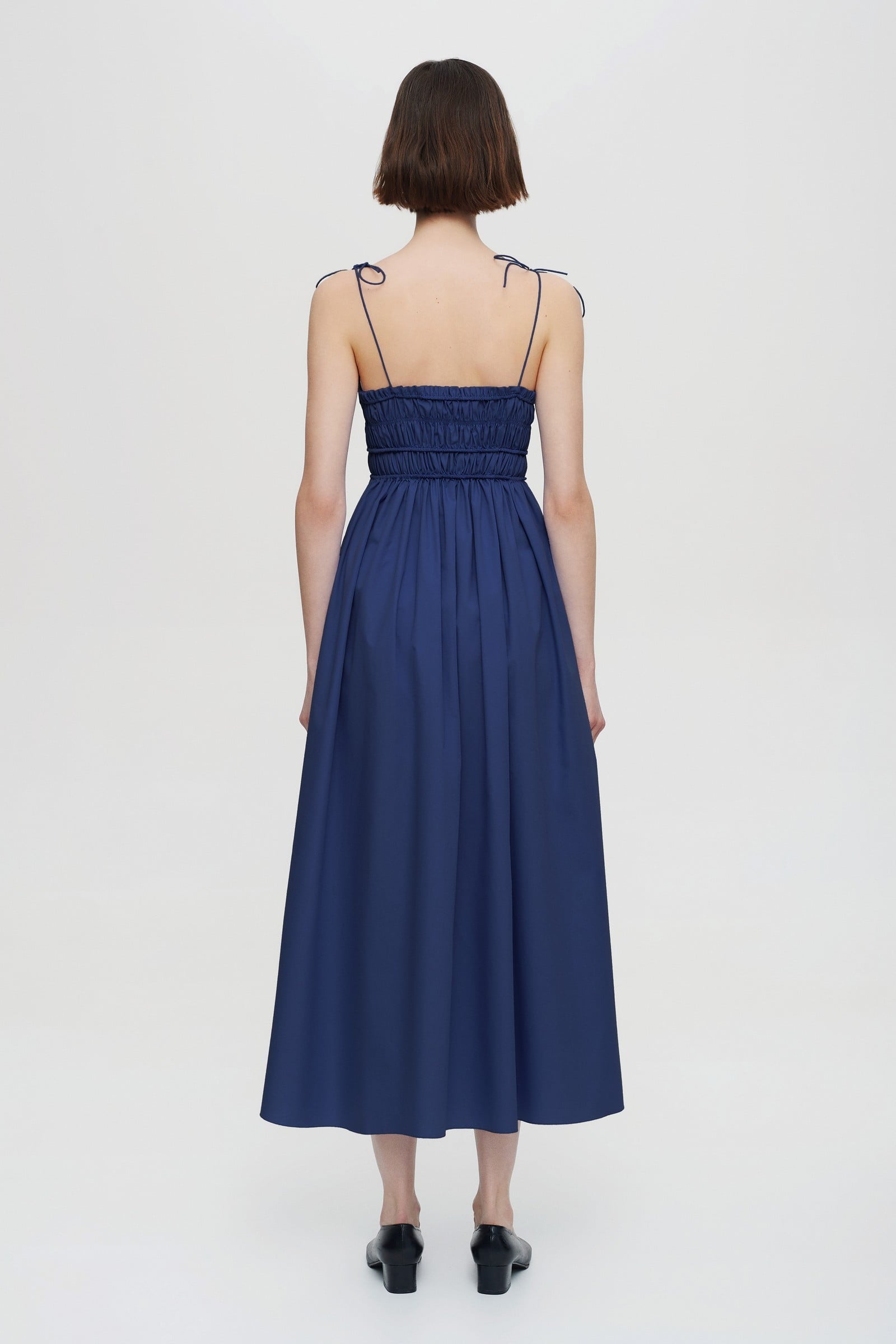 Model in pleated top midi Irresistible Flow dress back view