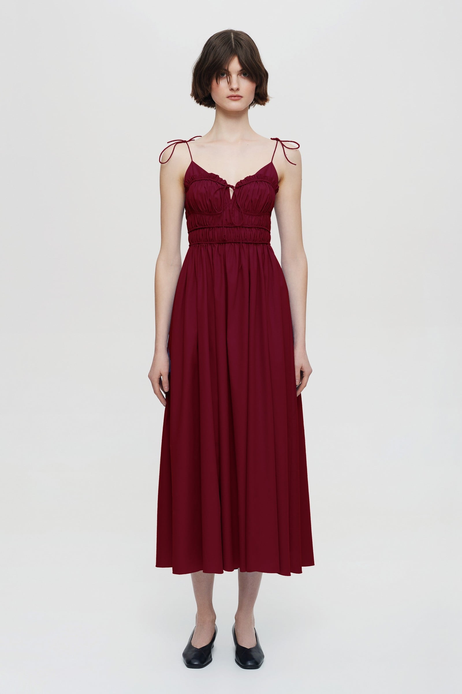 Model in pleated top midi Irresistible Flow dress front view